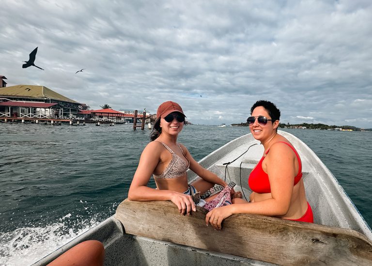 two women on boat at sea under grey clouds
