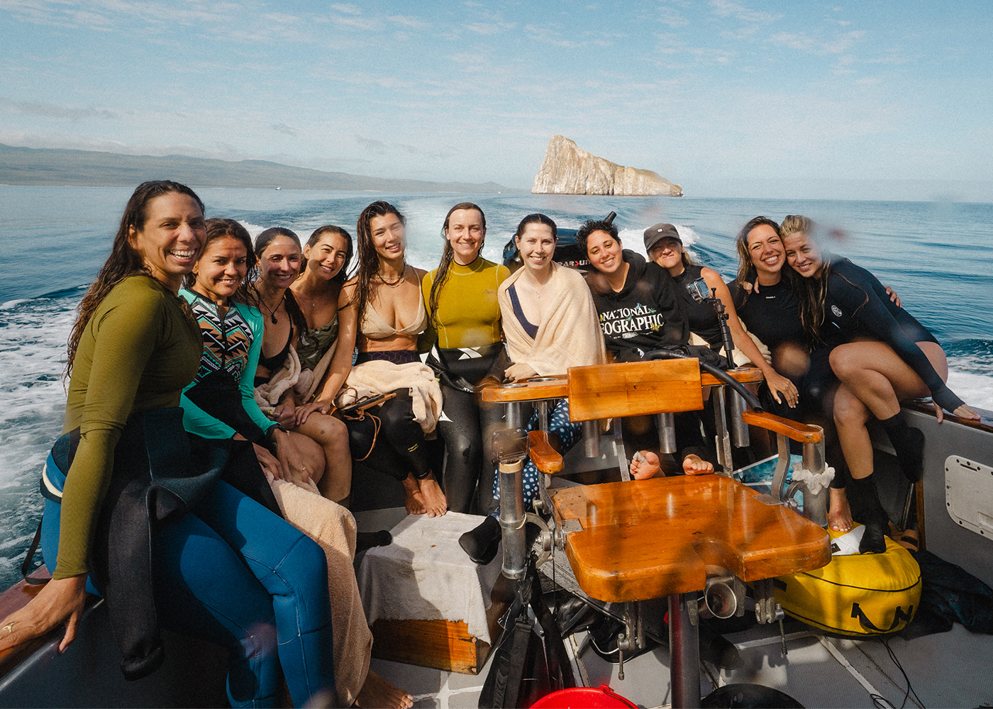 friends sitting on boat in open sea
