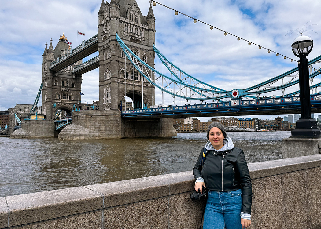 woman holding camera by London Bridge