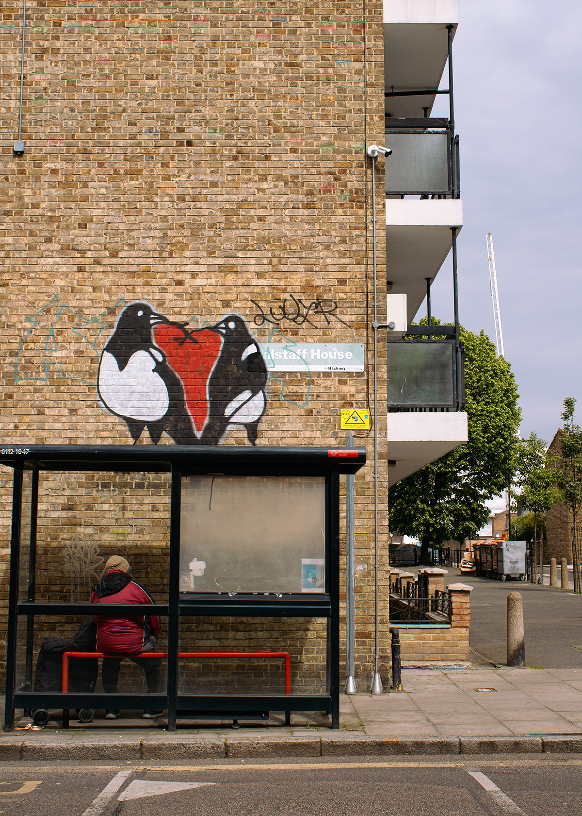 man sitting alone London bus stop