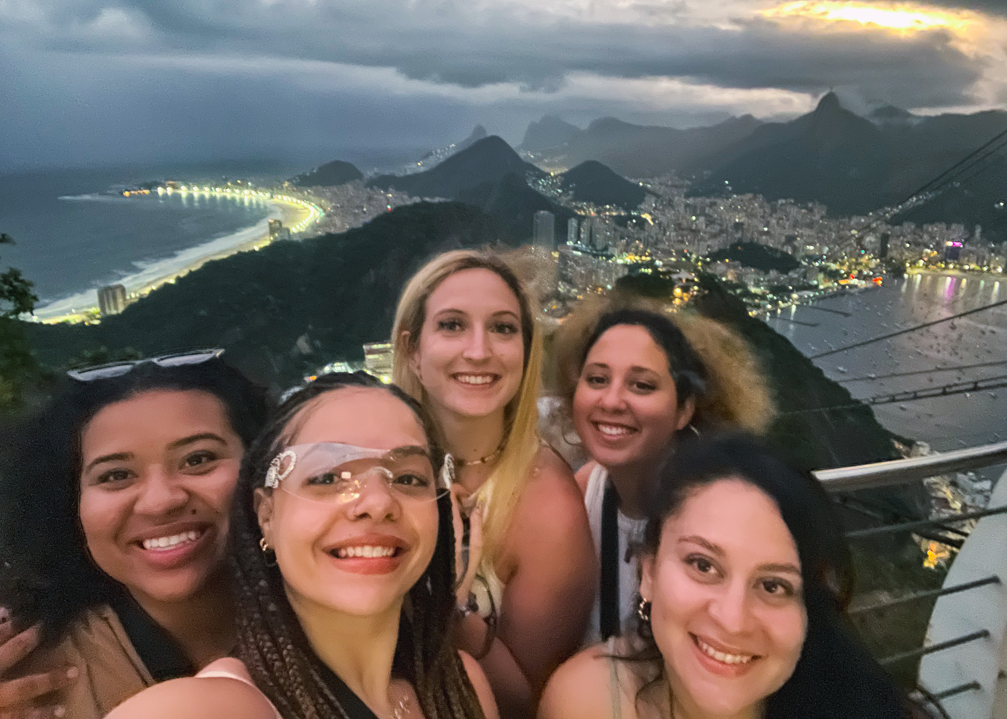 five friends in front of Rio de Janeiro city sunset view