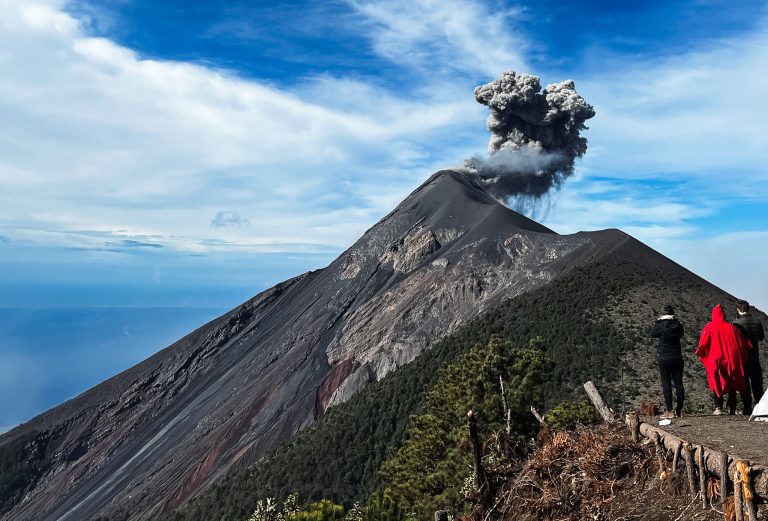 people watching smoking active volcano