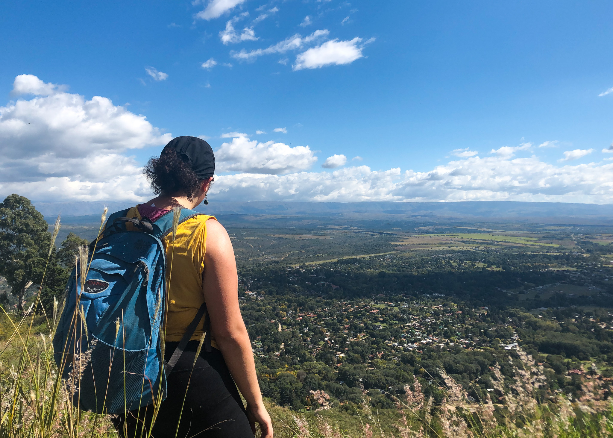woman hiking with green valley view