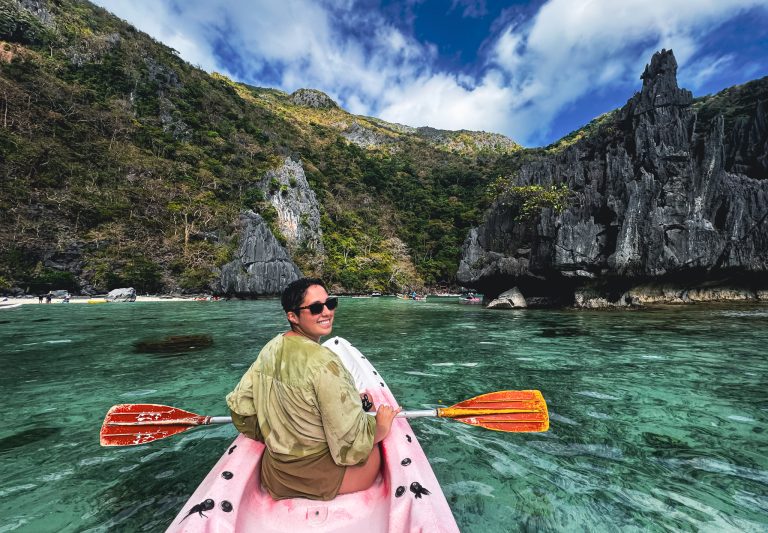 woman kayaking in blue lagoon Philippines