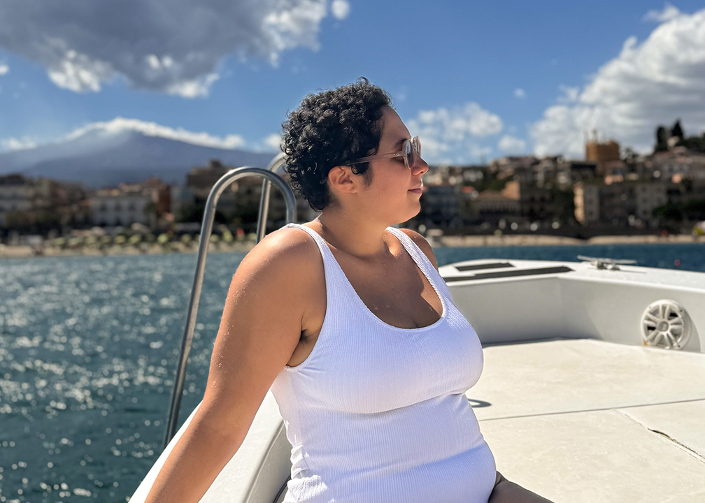 woman in white swimsuit on boat in sea